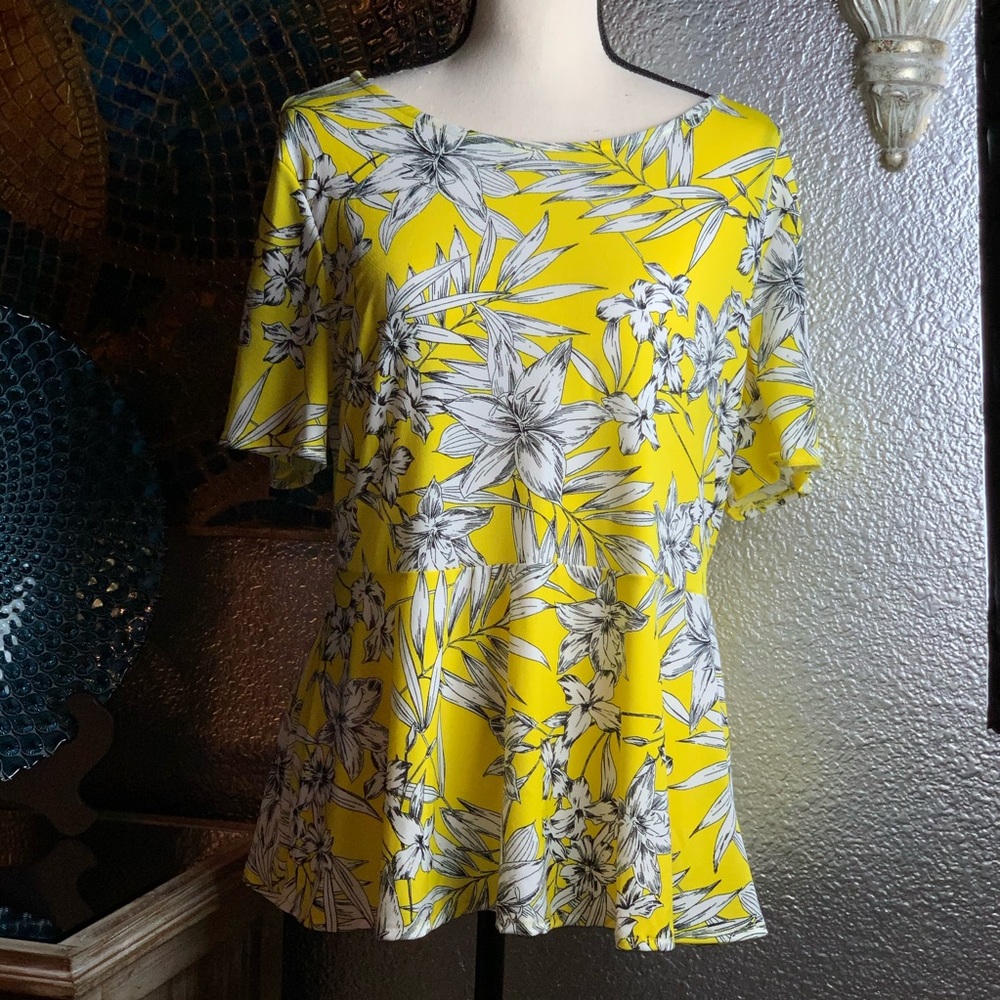 Eci bright yellow peplum top with floral design.